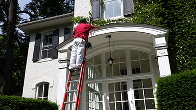 Oak Park handyman painting the front porch of an Oak Park home.