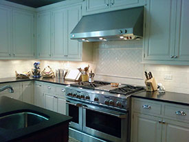 A stove exhaust and custom cabinets from one of our Oak Park kitchen remodels.